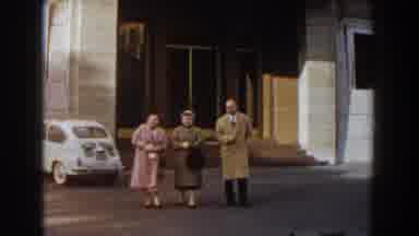 Barcelona Spain (1959): Two Mature Women And A Man Dressed In Coats Walk In Front