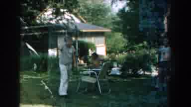 Michigan-1959: Adults And Children In Backyard With Green Lawn And House
