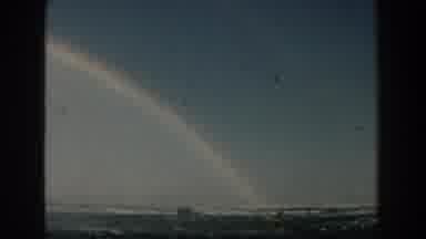 Michigan (1959): Beautiful Colorful Rainbow On Clear Blue Sky Ending At Beach With