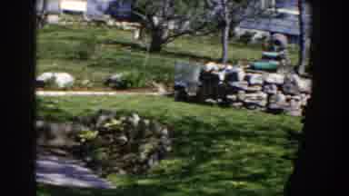Michigan (1959): A Suburban New England Backyard With A Stone Wall And Trees