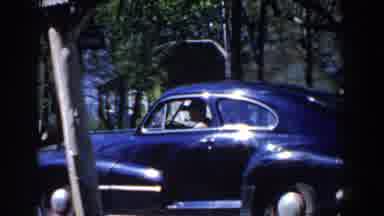 Michigan (1959): A Man With Pipe In Mouth Drives Fast In Car