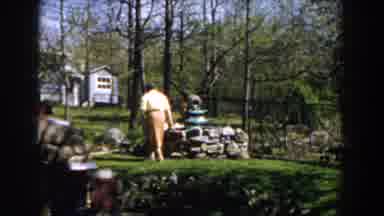 Michigan (1959): Lady Walking On The Grass In A Beautiful Place With Houses Midst