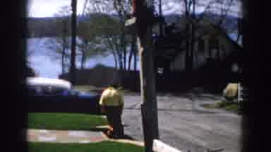 Michigan (1959): A Person Walking Outside Of Their Home Into The Street