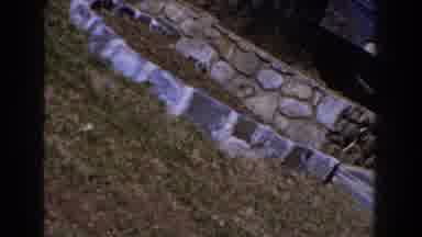 Michigan (1959): A Woman Watering The Grass With A Watering Can With Some Others