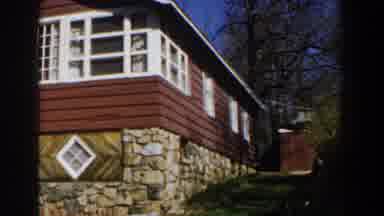 Michigan (1959): Red Siding White Trim On Cabin Atop Foundation Of Stones Camera