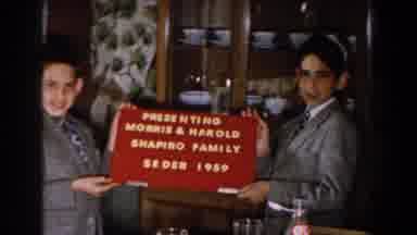 Michigan (1959): Two Boys Holding A Sign Presenting A Family Seder In A Family