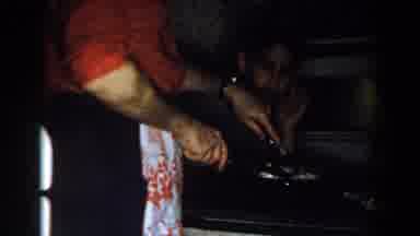 Michigan (1959): A Man Cooks And Serves His Wife And Kid On The Table