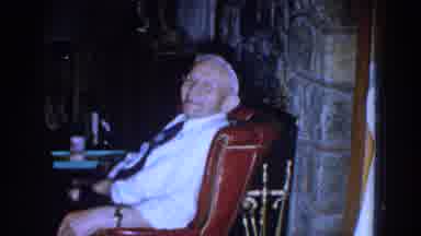 Michigan (1959): A Smiling Gentleman Sitting On A Leather Chair In A Room