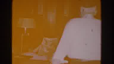 Michigan (1959): Man Walking Through His Home Past His Wife To Sit Down