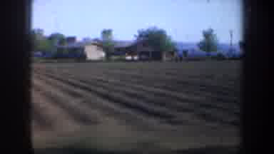 Oregon (1957): Passing View Of Brown Plowed Farmland And Trees On A Clear Day