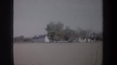 Oregon (1957): Passing View Of White Barn And Green Tree On A Sunny Day