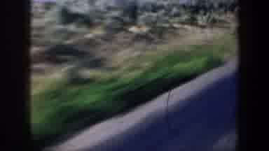 Oregon (1957): Passing View Of Brown Fields Blue Sky And Mountain Silhouette On A