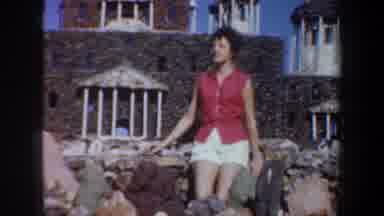 Oregon (1957): A Woman Appears Sitting In Front Of A Building At A Glance The