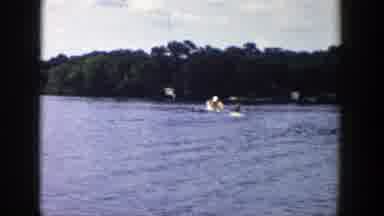 Wisconsin (1958): Water Skiing On The Lake With A White Ski Boat Going Slow