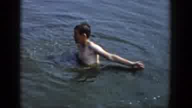 Wisconsin (1958): A Boy Plays With Water As His Parents Ride On A Boat