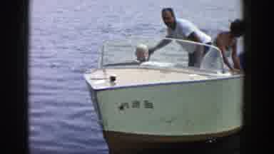 Wisconsin (1958): A Man Controls A Boat For His Wife While The Kid Runs After Them