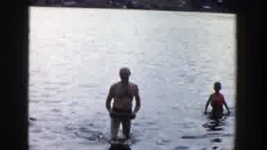 Wisconsin (1958): Family With Dad And Kids Playing With A Rubber Ring On Water