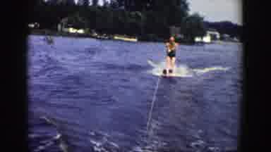 Wisconsin (1958): Person Water Skiing On Lake And Man Walking With His Young Son