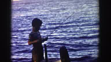 Wisconsin (1958): Boy Wearing Brown Shorts Stands On Wooden Platform Fishing On A