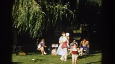 Wisconsin (1958): Group Of Adults And Children Some In Swim Gear Playing In A