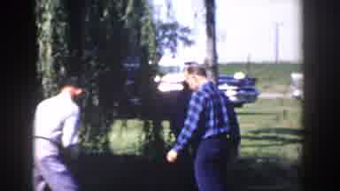 Wisconsin (1958): Two Men Are Busy Arranging Objects Picked From The Ground