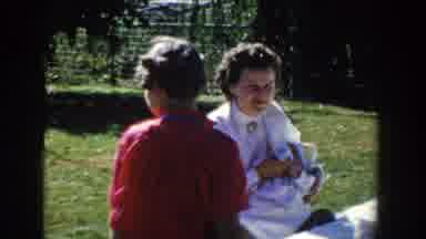 Wisconsin (1958): Old Footage Of Woman And Her Child Chilling Near The Grass In A