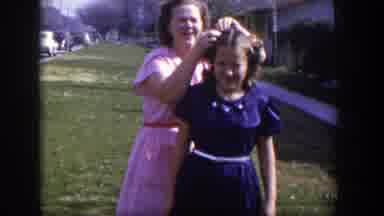 Las Vegas Nevada (1954): Woman Fixes Hair Of Young Girl Outside Near A Gathering