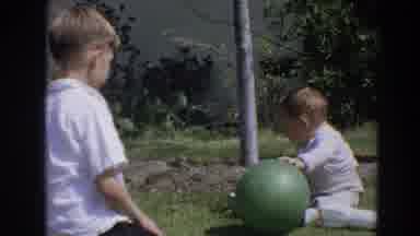 North Hollywood California (1964): Baby Wearing White Shirt Sits On Green Grass