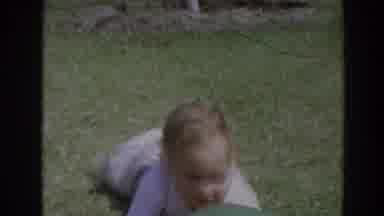 North Hollywood California (1964): A Little Boy Crawls To Grab A Ball Rolling On