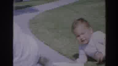 North Hollywood California (1964): A Baby Crawling On The Ground Or Yard In Front