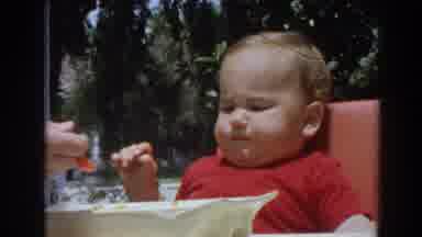 North Hollywood California (1964): A Baby Sitting In The Cradle Being Spoon Fed By