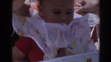 North Hollywood California (1964): Off Screen Person Puts White Bib On Babysitting