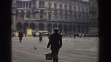 Pisa Italy (1959): Person Wearing Black Jacket Carries Black Bucket On A Cloudy