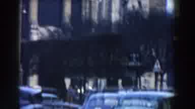 Pisa Italy (1959): Woman Wearing Pink Coat Stands Near Brown Pole On A Cloudy Day