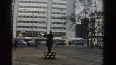 Pisa Italy (1959): Person Wearing Black Coat Directs Traffic On A Clear Day