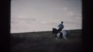 South Dakota (1953): Person Wearing Blue Pants Rides Black And White Horse Through