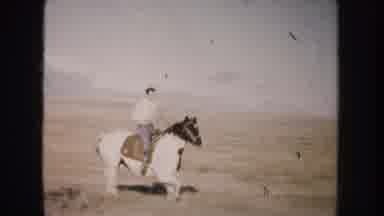 South Dakota (1953): A Boy Horseback Riding And Smiling To The Camera In A Field