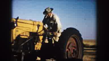 South Dakota (1953): A Man Climbs A Tractor To Begin His Land Cultivation