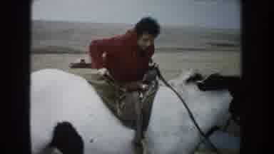 South Dakota (1953): Woman Climbs Onto Saddle On White Horse With Brown Spots As