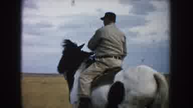 South Dakota (1953): Man Rides Brown And White Horse In Rural Area Red Pickup