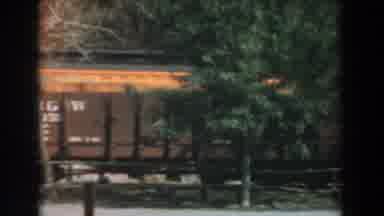 Knotts Berry Farm California (1961): A Well Dressed Woman Is Walking Past A Moving