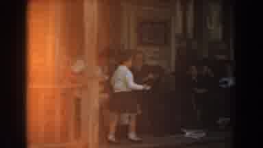 Knotts Berry Farm California (1961): A Boy Walks Past Some Adults Sitting And