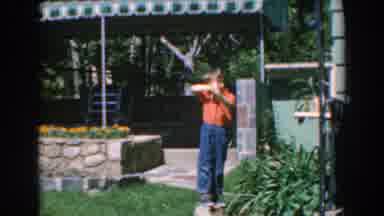 GREECE-1962: Young Boy Playing With Toy Gun And Women Walking In Garden
