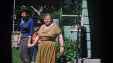 GREECE-1962: Women Holding Hands And Playing With A Boy In Backyard