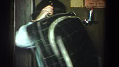 New York City (1960): A Woman Earring And A Big Baggage Laughing And She Does Not