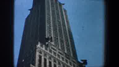 New York City (1960): A Vertical Shot Of A Very High Skyscraper With A Blue Sky In