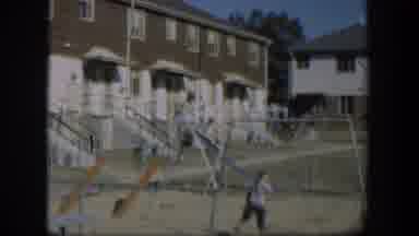 Nevada-1954: Kids Play On Playground Area In Back Of Attached Housing Units
