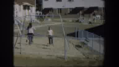 Nevada-1954: Children Playing On Swing Set In Apartment Playground
