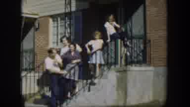 Nevada (1954): Five People Standing Near Red Brick House On A Bright Sunny Day