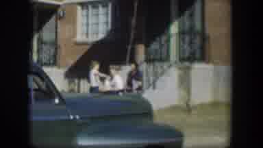 Nevada (1954): Three People Sitting On Some Steps That Lead Up To A Building